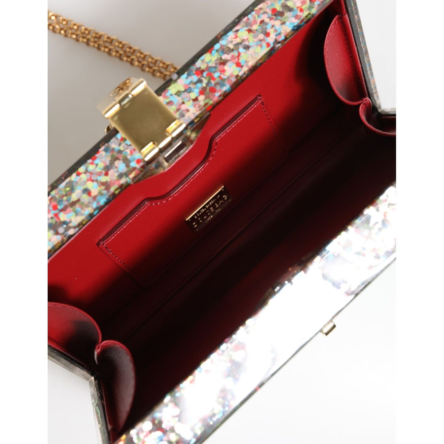 Interior view of Dolce & Gabbana Multicolor PurseBox Fashion Sinner Glitter Crossbody Bag with red lining and gold chain strap.