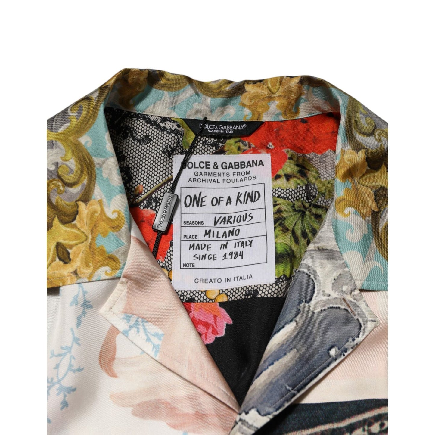 Close-up of Dolce & Gabbana Multicolor Silk Opera Print Men Casual Shirt label showing intricate design and brand details.