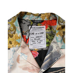 Close-up of Dolce & Gabbana Multicolor Silk Opera Print Men Casual Shirt label showing intricate design and brand details.