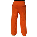 Back view of Dolce & Gabbana Orange Cotton DG VIB3 Logo Drawstring Sweatpants Pants showcasing rear pockets and bold color.