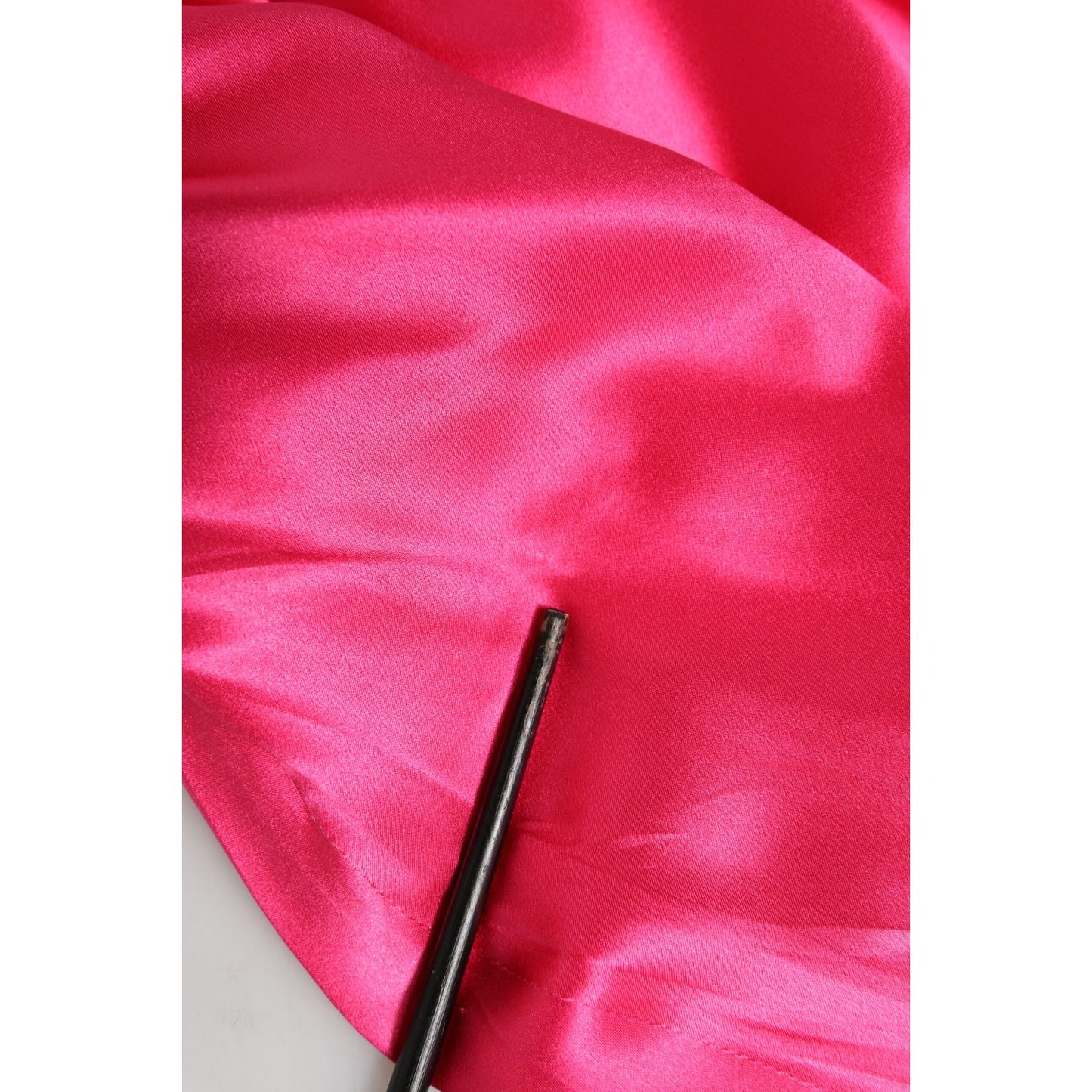 Close-up of Dolce & Gabbana Pink Sheath Silk Bow Open Shoulder Dress fabric in vibrant fuchsia silk with luxurious smooth texture.