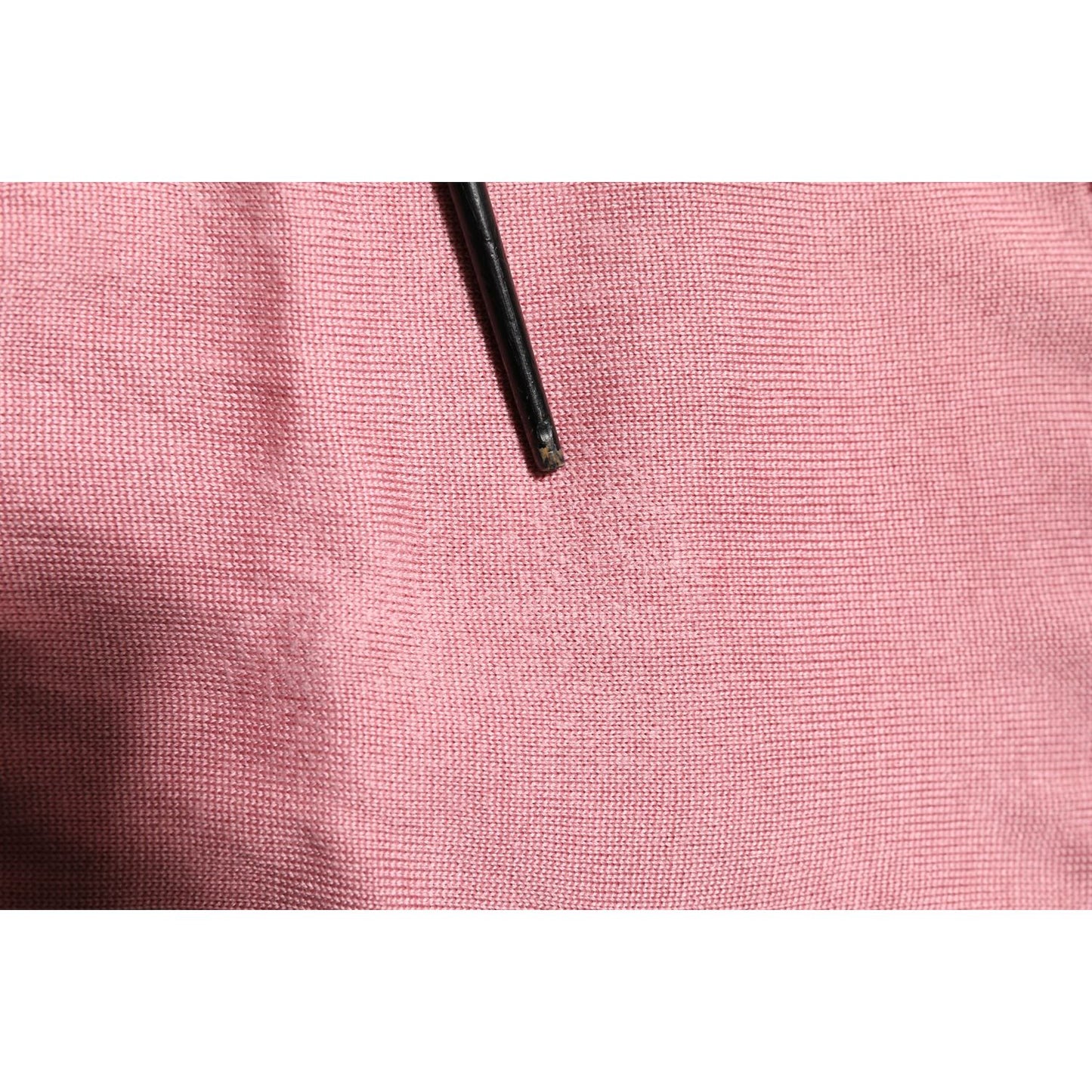 Detail of Dolce & Gabbana Pink Silk Cropped Crew Neck Cardigan Sweater showing fabric texture and pulled threads.