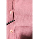 Close-up of Dolce & Gabbana Pink Silk Cropped Crew Neck Cardigan Sweater with button details and pulled threads.