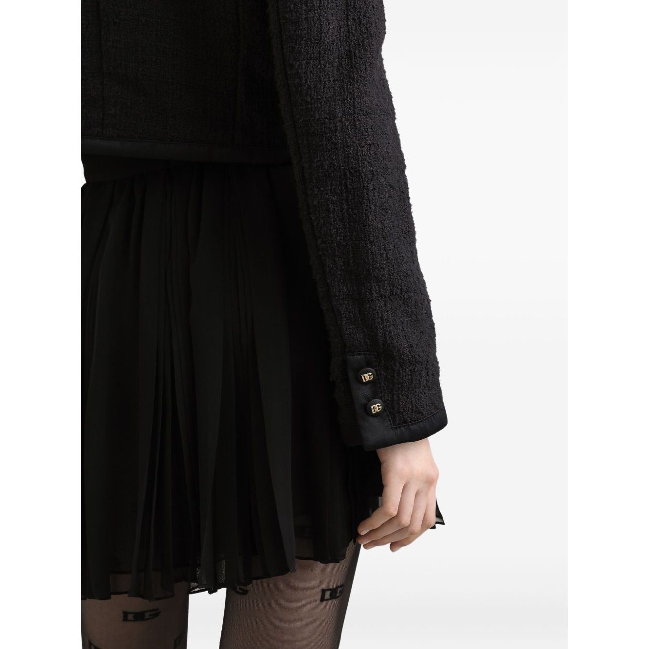 Dolce & Gabbana Rachel Tweed Jacket in black with button cuffs, crew neck, and four front patch pockets on cotton blend. Side view.