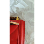 Close-up of Dolce & Gabbana Red Quilted Devotion Crossbody 11 PRO Phone case bag with gold chain detail.
