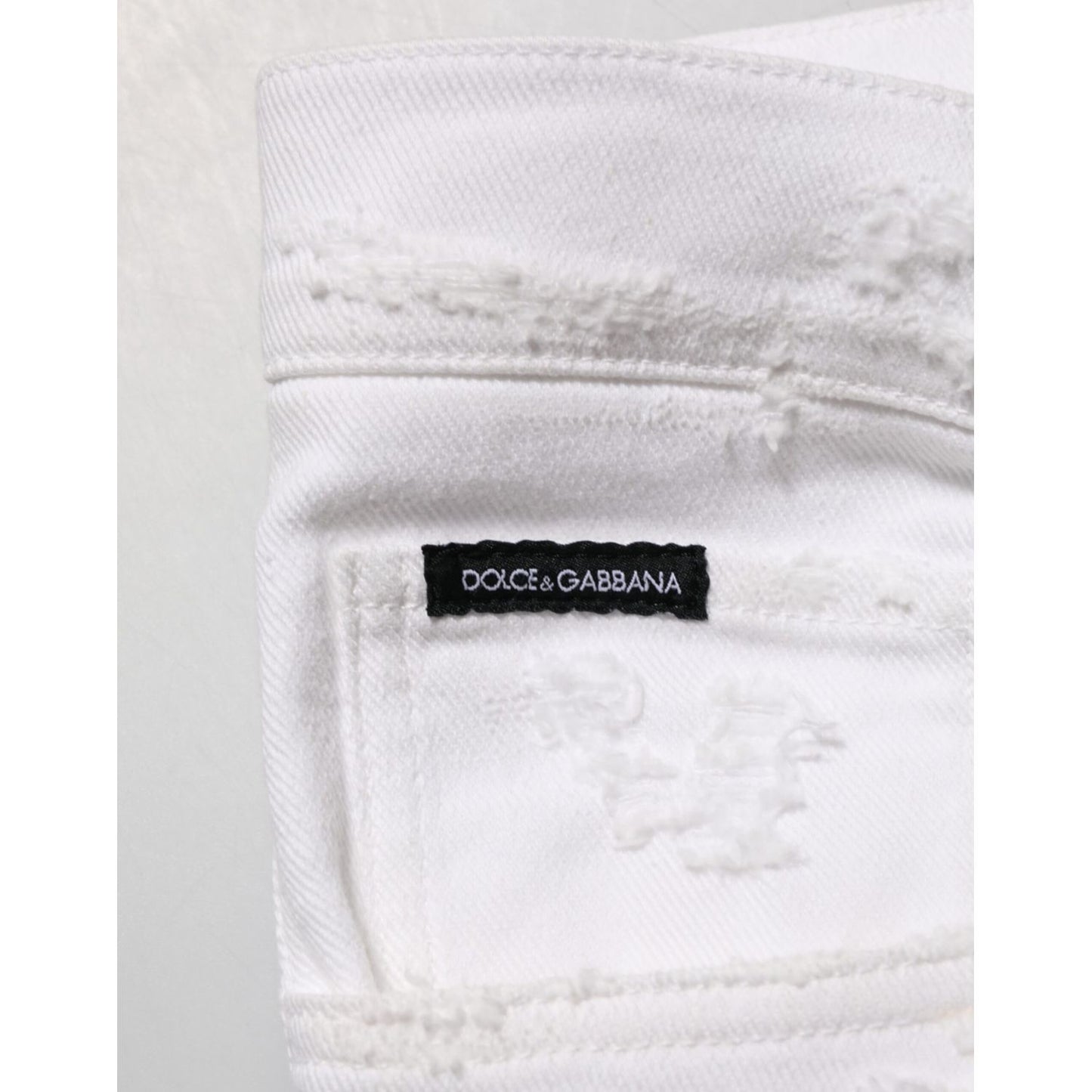 Detail of Dolce & Gabbana White Distressed Ripped Denim Trouser Jeans with label