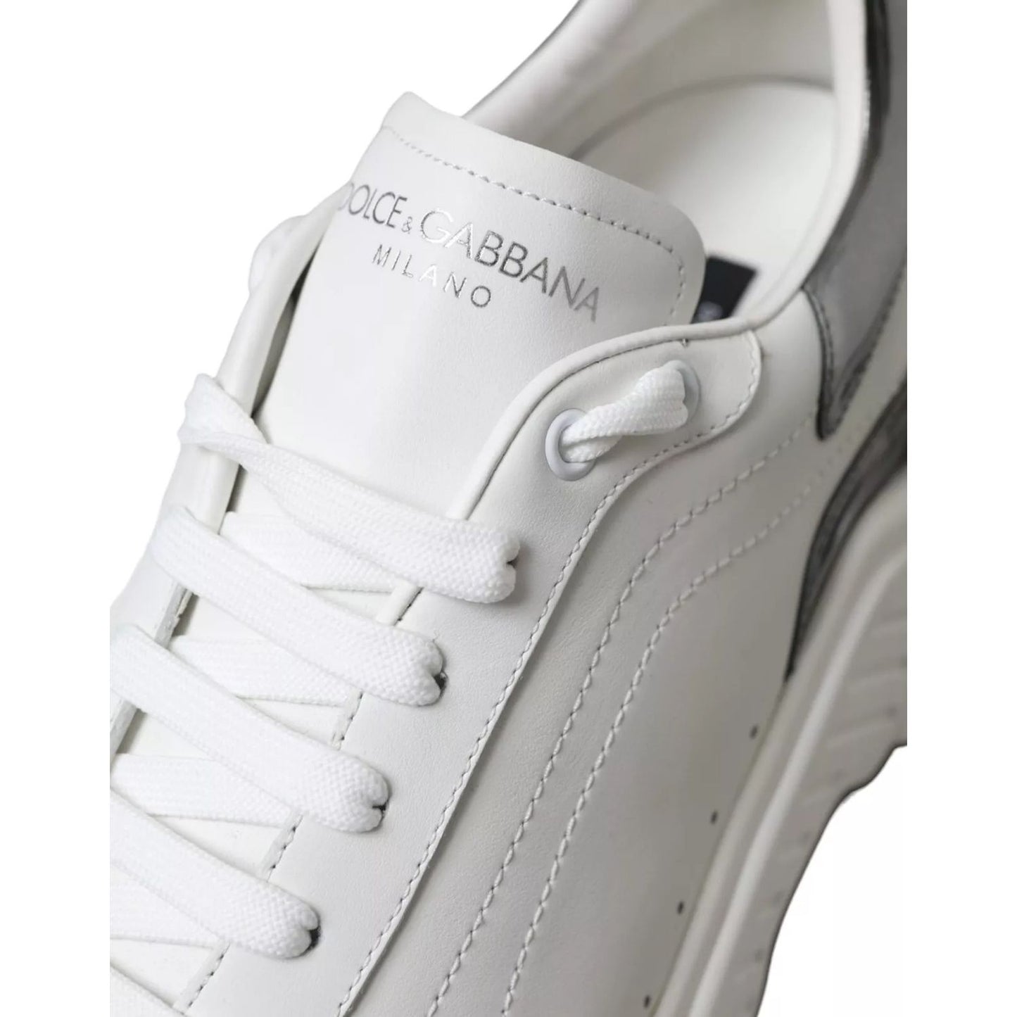 Close-up of Dolce & Gabbana White Silver Leather Sport DAYMASTER Sneakers showing logo and stitching details.