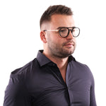 Man wearing Dsquared² Sleek Black Full-Rim Designer Eyewear with black frames and a dark shirt, showcasing unisex style.