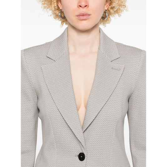 Emporio Armani Icon Blazer in light grey with button fastening, two side pockets, and shoulder pads, modeled by person wearing size 40 IT.