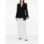 Woman wearing Emporio Armani Jackets Black, single-breasted blazer with notched lapel and welt pockets, paired with white trousers.