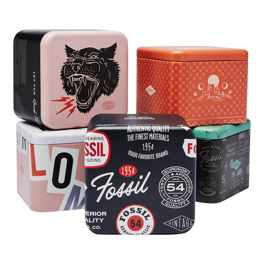Stack of colorful Fossil product tins for FOSSIL Mod. FENMORE wristwatch collection.