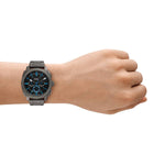 FOSSIL Mod. MACHINE wristwatch for gents with 44 mm case, shown on wrist. Comes in official box packaging.