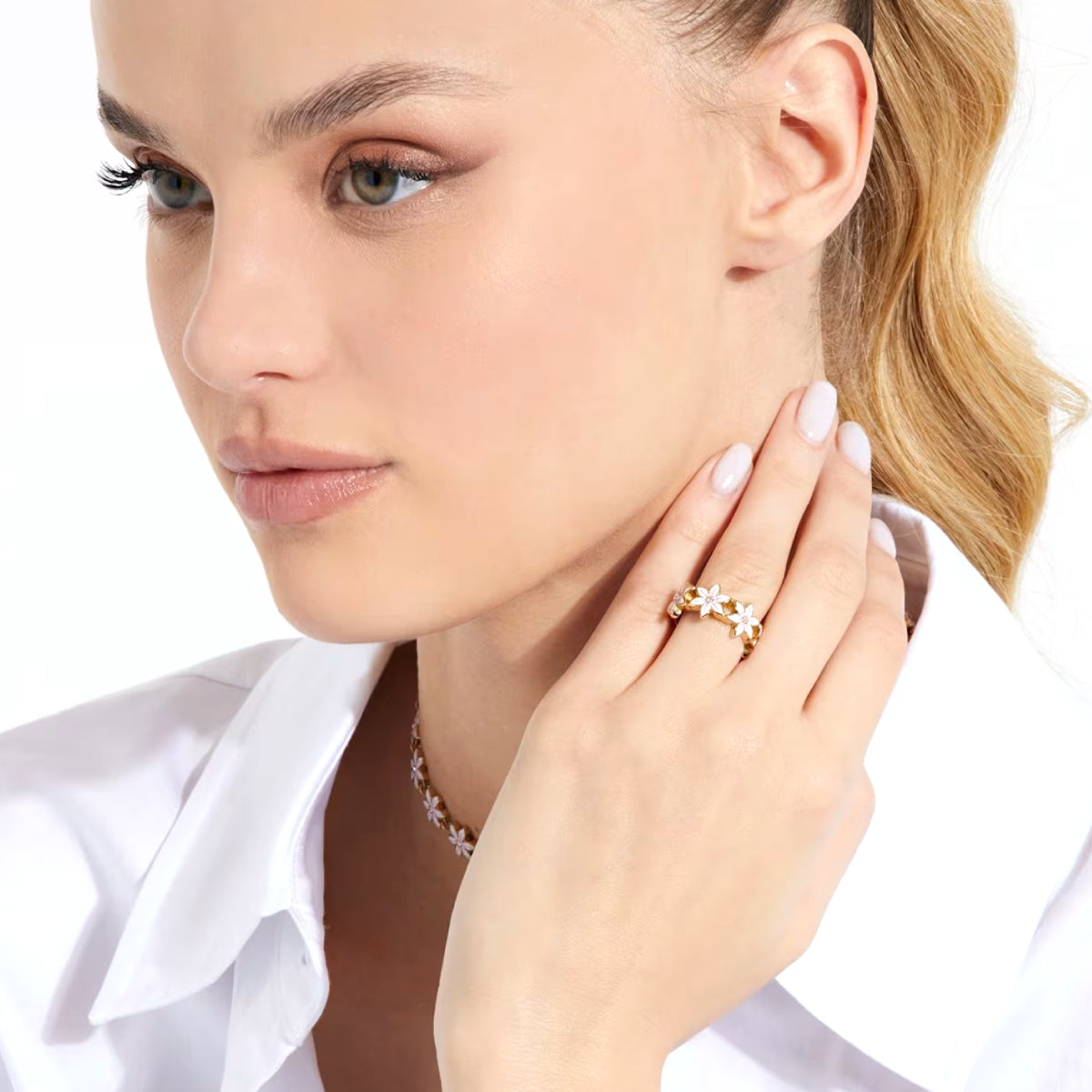 Woman wearing GUESS JEWELS JEWELRY Mod. JUBR04132JWYGWH52 showcasing elegant ring and necklace