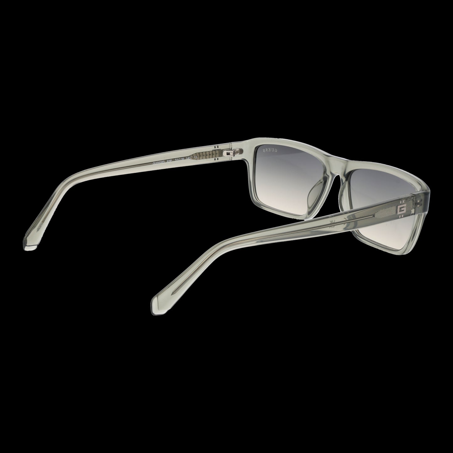 GUESS MOD. GU00085 5593P gent sunglasses with transparent frame and gradient lenses, side view against black background
