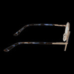 Side view of GUESS MOD. GU8273 47032 eyeglasses featuring tortoiseshell arms and gold details on a black background.