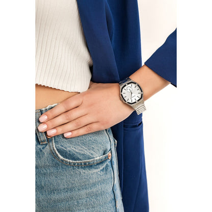 Woman wearing GUESS Mod. GW0310L1 silver quartz analog watch with denim jeans, highlighting elegant fashion accessory.
