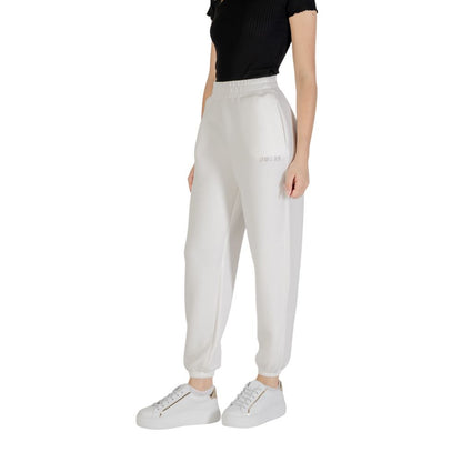 Woman wearing Guess Active Cream Viscose Joggers (Workout Pants) with elastic waistband and casual sporty look.