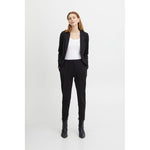 Woman wearing ICHI Black Polyester Pant with blazer, showcasing front pleats and elastic waist.