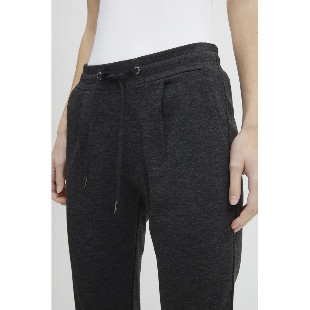Woman wearing ICHI Gray Polyester Pant with drawstring waistband and front pleats for modern style and comfort.