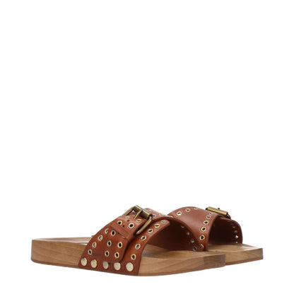 Isabel Marant Brown Leather Slippers with buckle closure and studded design, featuring a low, flat heel and rubber sole.