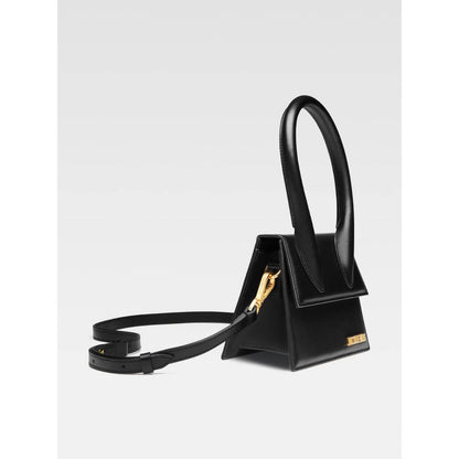 Jacquemus Le Chiquito Moyen Black Bag with gold hardware, magnetic flap, and removable shoulder strap, side view.