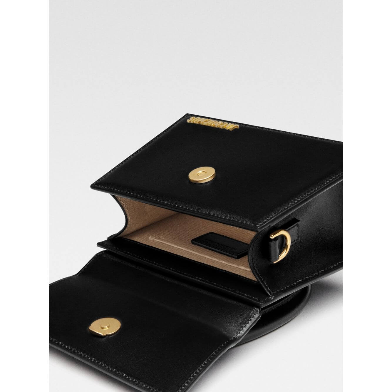 Open Jacquemus Le Chiquito Moyen Black Bag showing gold hardware and inside pocket with removable shoulder strap.