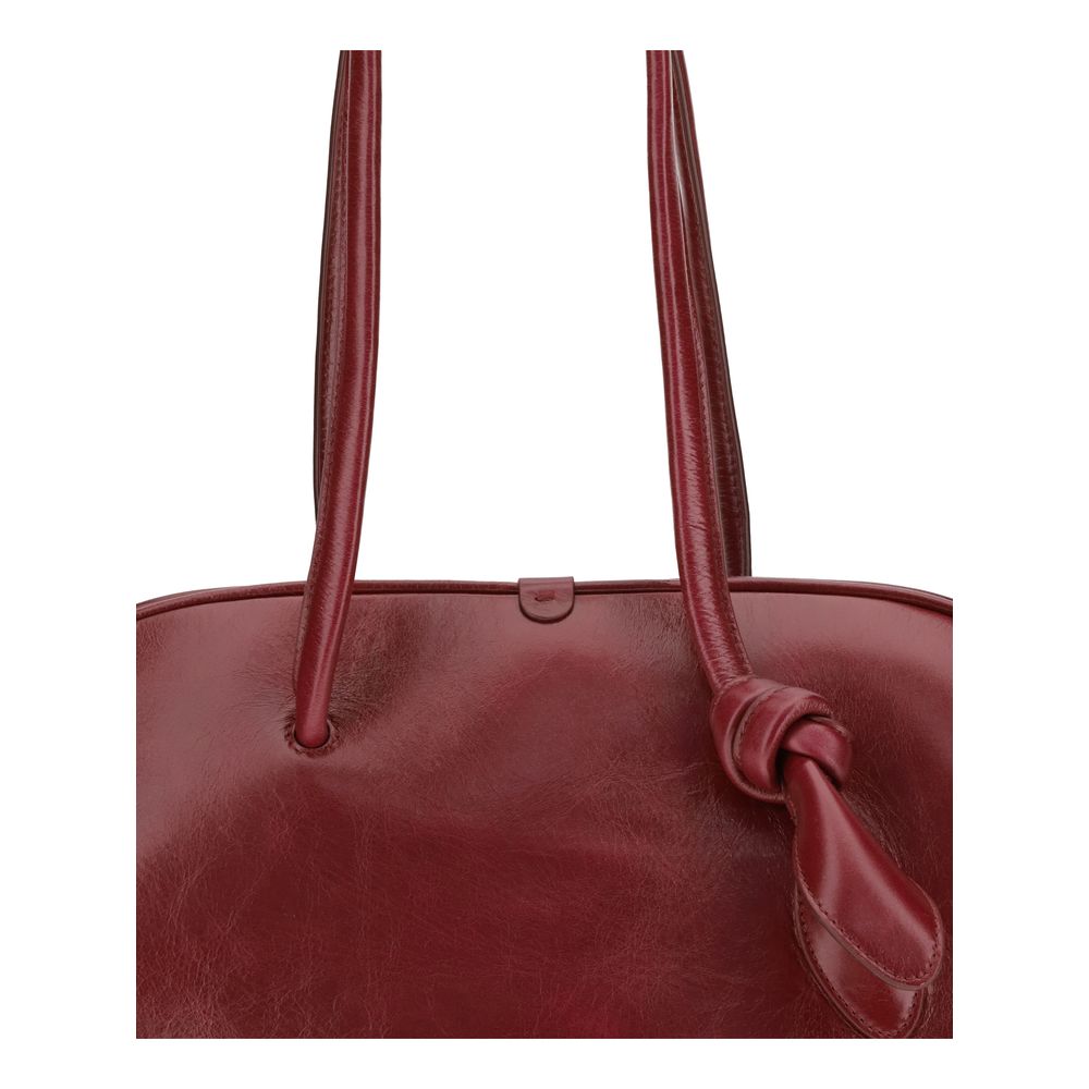 Front view of Jacquemus Red Calf Leather Bos Taurus Shoulder Bag with tubular handles and knotted detail, showcasing glossy vintage finish.