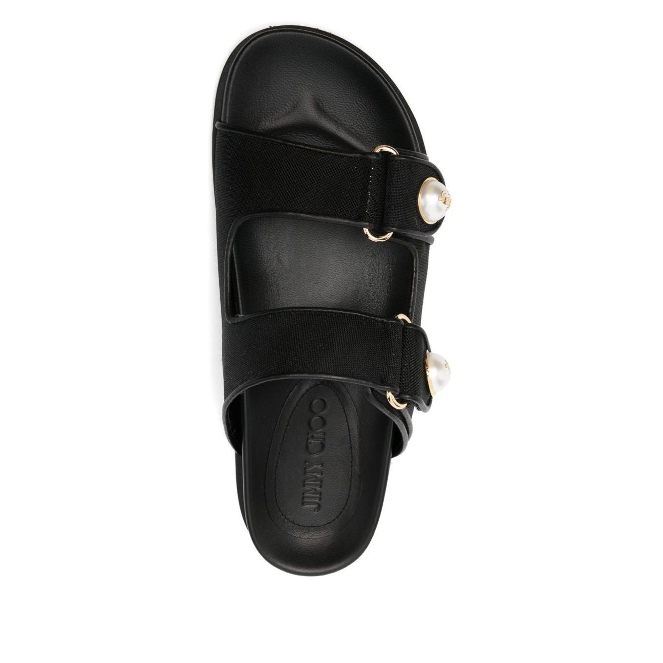 Overhead view of Jimmy Choo Fayence Sandal Low leather sandals with pearls, featuring black rubber sole and faux pearl embellishments.