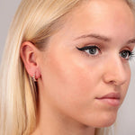 LA PETITE STORY Mod. LPS02ARQ107 brass single earring for ladies modeled on woman with blonde hair