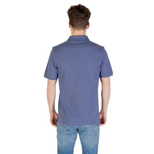 Back view of Lyle & Scott Blue Cotton Polo Shirt on a man wearing jeans.
