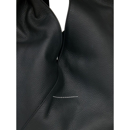 Close-up of MM6 Maison Margiela Classic Japanese handbag in black leather, showing single top handle and textured material.
