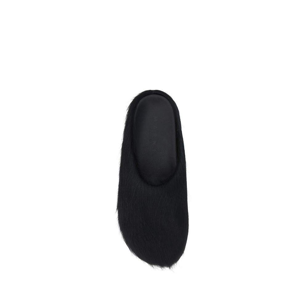 Top view of Marni Fussbett Mules in black leather with colored fur design, featuring a slip-on style and flat rubber sole for comfort.