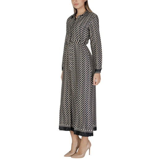 Woman wearing Only Black Recycled Polyester Long fall/winter dress, composed of 68% recycled polyester and 32% polyester, standing sideways.