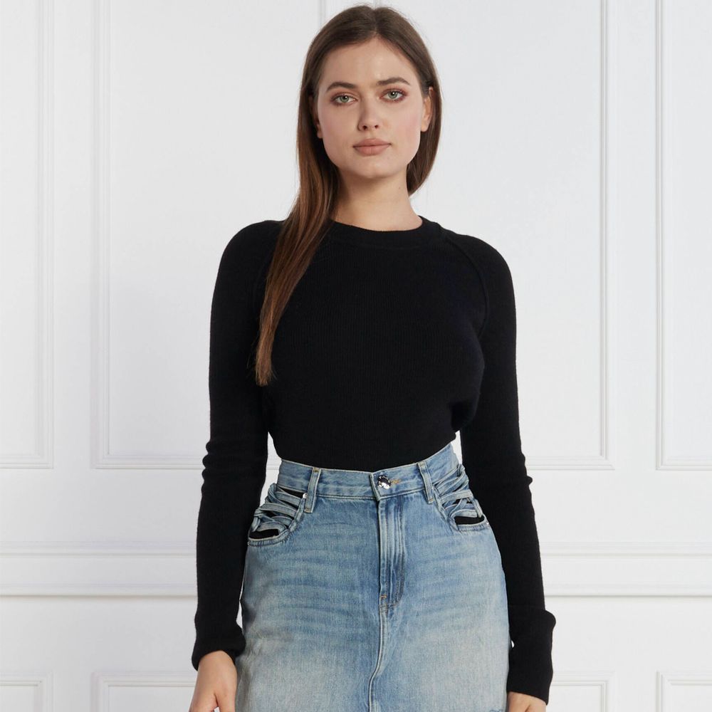 Woman wearing PINKO Black Wool Sweater with crew neck and metal logo detail, paired with denim jeans in a stylish indoor setting.