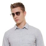 Gent wearing POLICE MOD. SPL783 54579X sunglasses with plastic frame and UV protection in official box packaging.