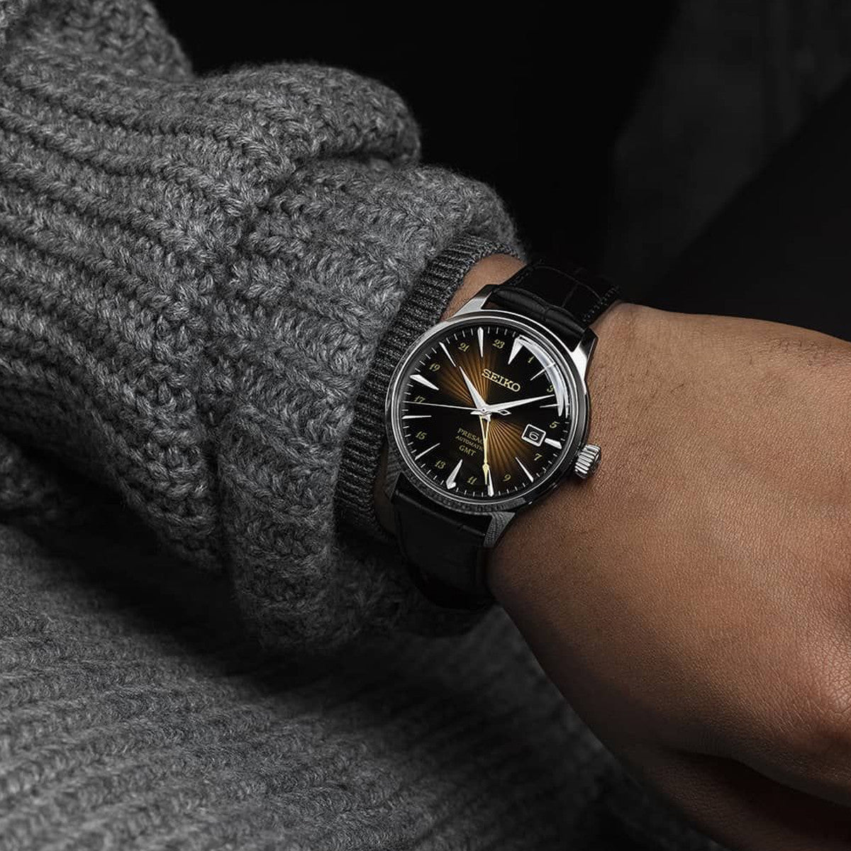 SEIKO PRESAGE Mod. COCKTAIL AUTOMATIC - RUSTY NAIL wristwatch with leather strap on model's wrist, highlighting design and dial.