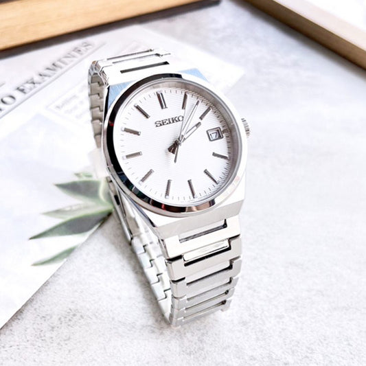SEIKO WATCHES Mod. SUR553P1 with stainless steel bracelet and sapphire dial, water resistant to 10 ATM, displayed on a grey surface.