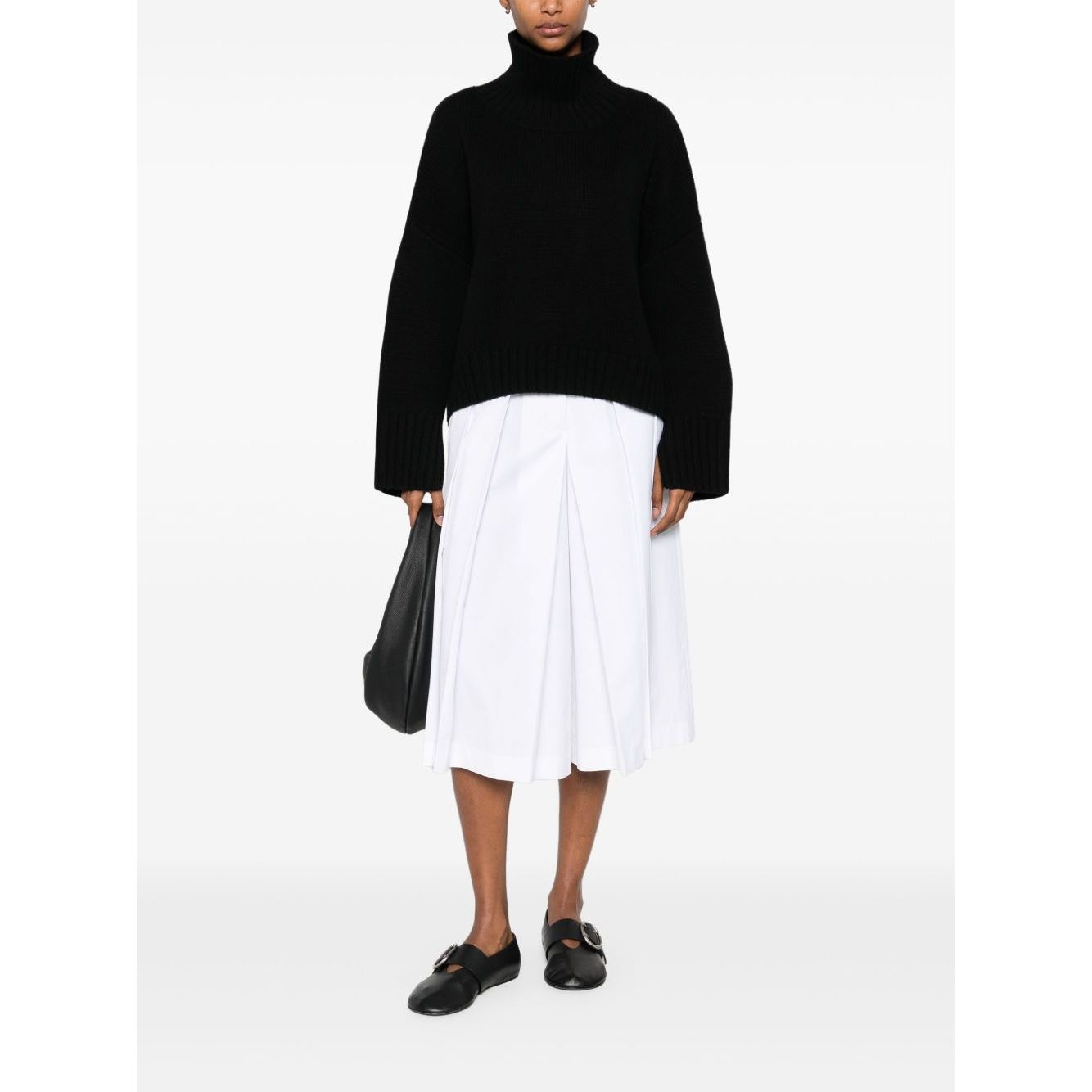 Model wearing SOFT GOAT Sweaters Black ribbed trim high neck cashmere jumper with long sleeves.