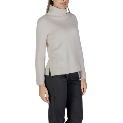 Woman wearing a Street One Cream Viscose Turtleneck with side buttons and long sleeves, showcasing stylish and versatile knitwear.