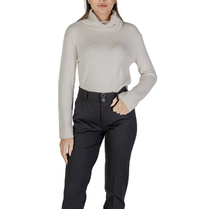 Woman wearing Street One Cream Viscose Turtleneck with black pants, showing side button details.