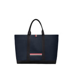 Thom Browne Medium drawstring opening tool tote bag in navy blue with RWB stripe, featuring top drawstring fastening and two handles.