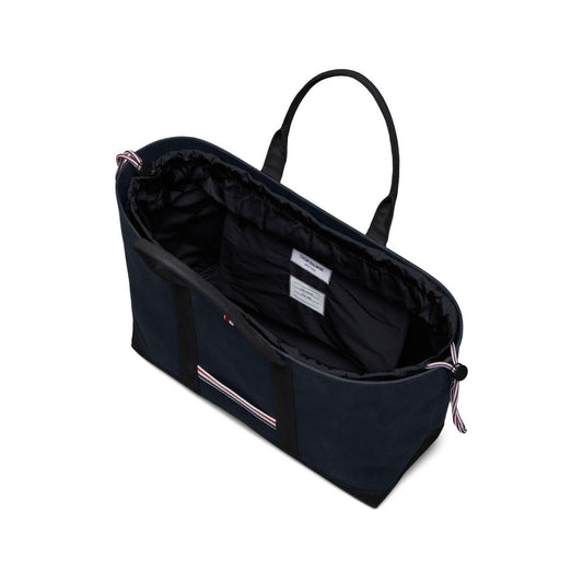 Thom Browne Medium drawstring opening tool tote bag in navy with RWB stripe, featuring two top handles and protective dust bag.