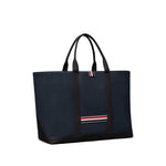 Thom Browne Medium drawstring opening tool tote bag in navy blue with RWB stripe, featuring top drawstring fastening and two handles.