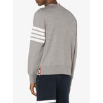 Back view of Thom Browne Sweaters Light Grey with 4-Bar stripe and tricolour grosgrain loop on model in navy pants.