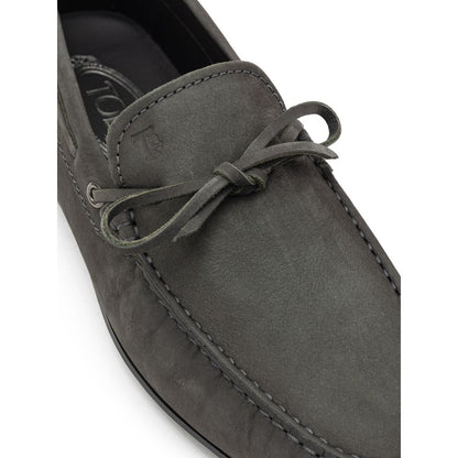 Close-up of Tod's Gray Nubuc Leather Moccassin with decorative lace and Gommino sole, showcasing Italian craftsmanship and style.