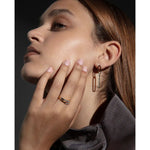 Woman wearing VICEROY JEWELS Mod. 9137E100-30 earrings and ring in a stylish pose, showcasing silver jewelry with mineral dial accent.