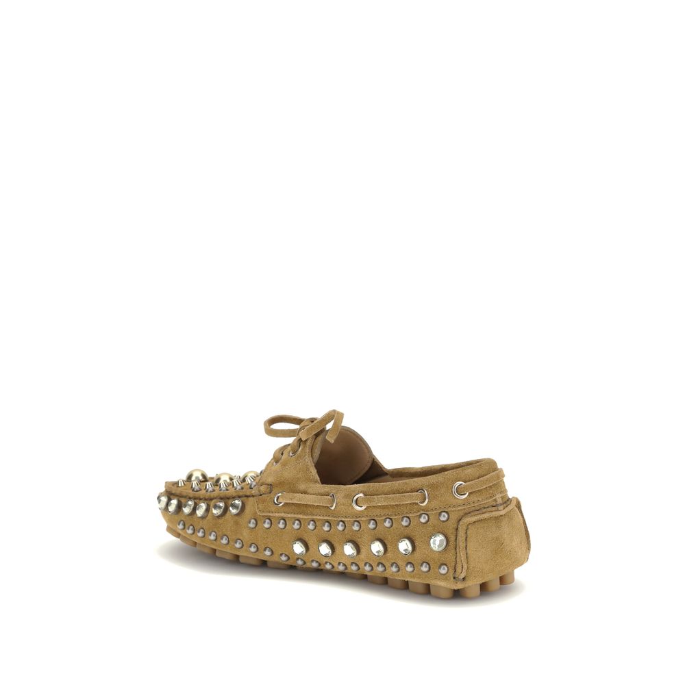 Side view of Valentino Garavani Beige Calf Leather Bos Taurus Slip-On Loafers with metal studs and rhinestones.