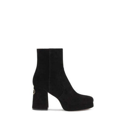 Valentino Garavani Black Calf Leather Bos Taurus Ankle Boots with VLogo detail and brass finish, platform heel, side zipper closure.