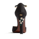 Back view of Valentino Garavani Hi Dolly Pumps In Fabric With Floral Embroidery 105mm, showcasing daisy embroidery and black ankle strap.