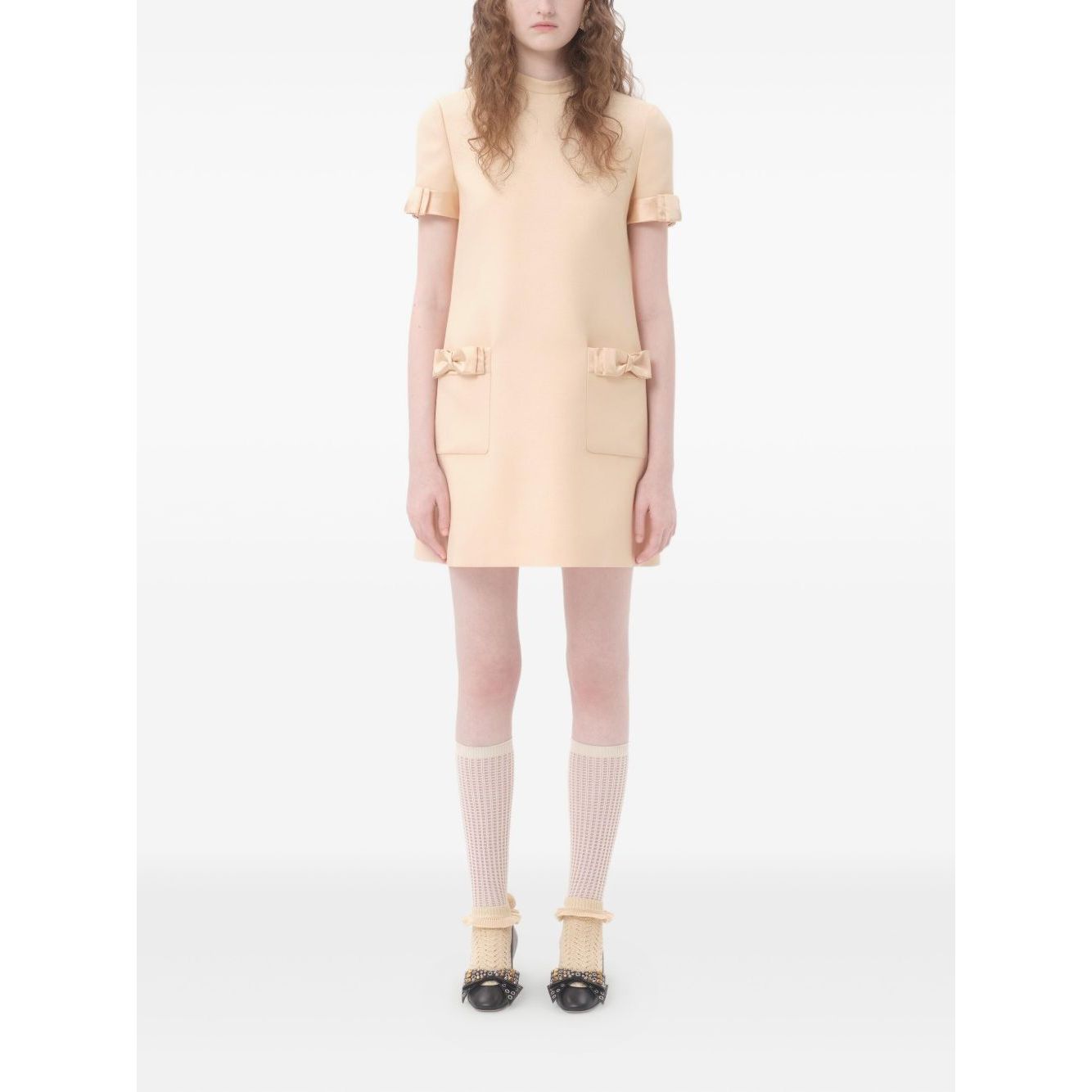 Valentino Short Crepe Couture Dress in beige with bow detailing, crew neck, and rear zip fastening, crafted from wool and silk.